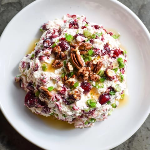 Creamy Cranberry Jalape&amp;#241;o Dip, topped with honey and pecans: sweet, spicy, and festive!