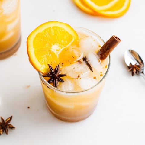 Refreshing homemade Cinnamon-Spiced Chai Fizz mocktail, with citrus aroma, perfect for brunch.
