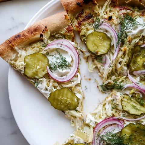 A unique Pickle Pizza featuring crispy pickles and rich crème fraîche sauce.  