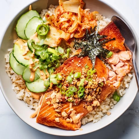 A delicious Crispy Salmon Rice Bowl with golden rice and vibrant veggie toppings.  