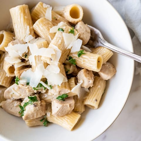 A delicious bowl of Creamy Garlic Parmesan Chicken Rigatoni ready for sharing at dinner.  