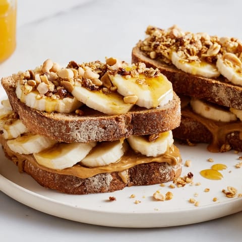 A close-up of a stacked peanut butter and banana sandwich, showcasing the fresh ingredients.