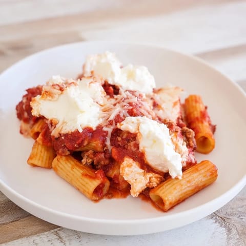 A close-up of creamy, cheesy slow cooker baked ziti, a comforting Italian-American pasta dish.