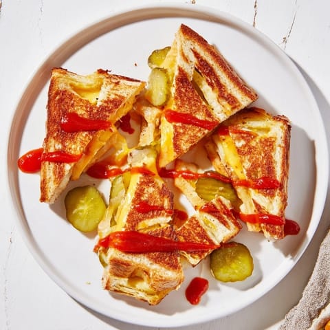 Mouthwatering close-up of Spicy Pickle Grilled Cheese Dippers, highlighting the spicy pickles bursting with flavor.