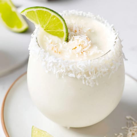 Creamy White Christmas Margarita Slush, a frosty blend of coconut, lime, and tequila.