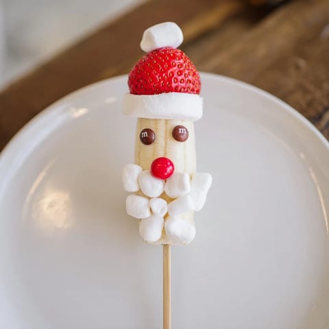 Close-up of bright and cheery Banana Santa Snack Sticks, a delightful holiday snack for kids.
