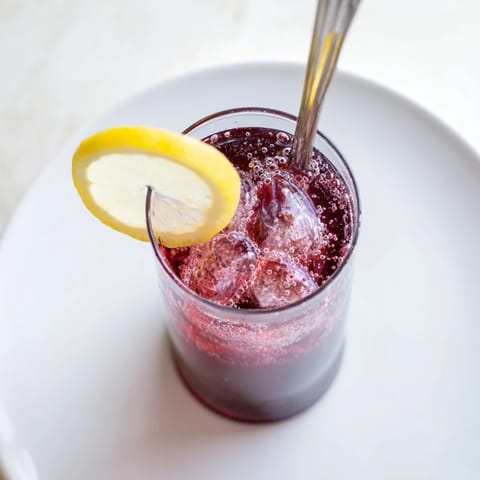 Refreshing Sleepy Girl Mocktail swirling in a tall glass, perfect for a relaxing evening, vegan.
