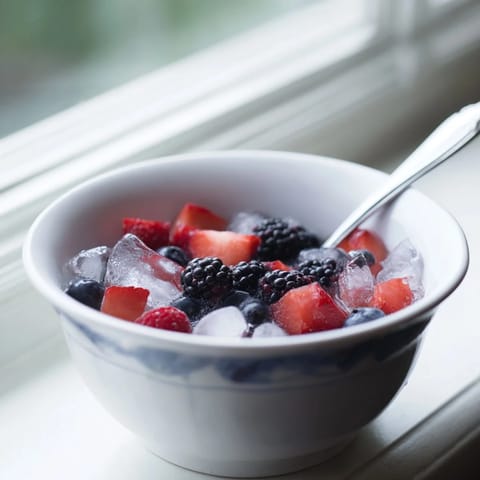 A cooling, colorful Nature's Cereal Bowl brimming with fresh fruit, perfect for a vegan breakfast.