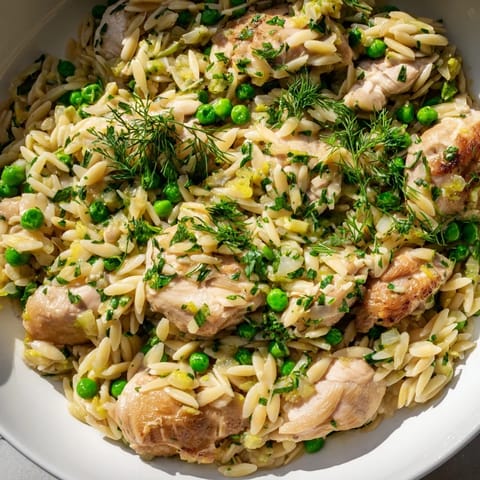 A visually appealing, one-pan Lemon Herb Chicken Orzo skillet, ready to serve for a simple dinner.