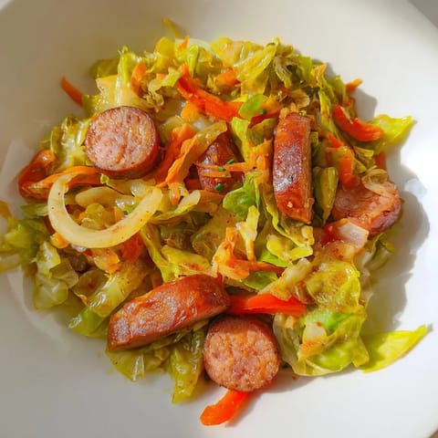 Golden-brown sausage and caramelized onions mingle with soft cabbage in this Southern-style skillet meal.  