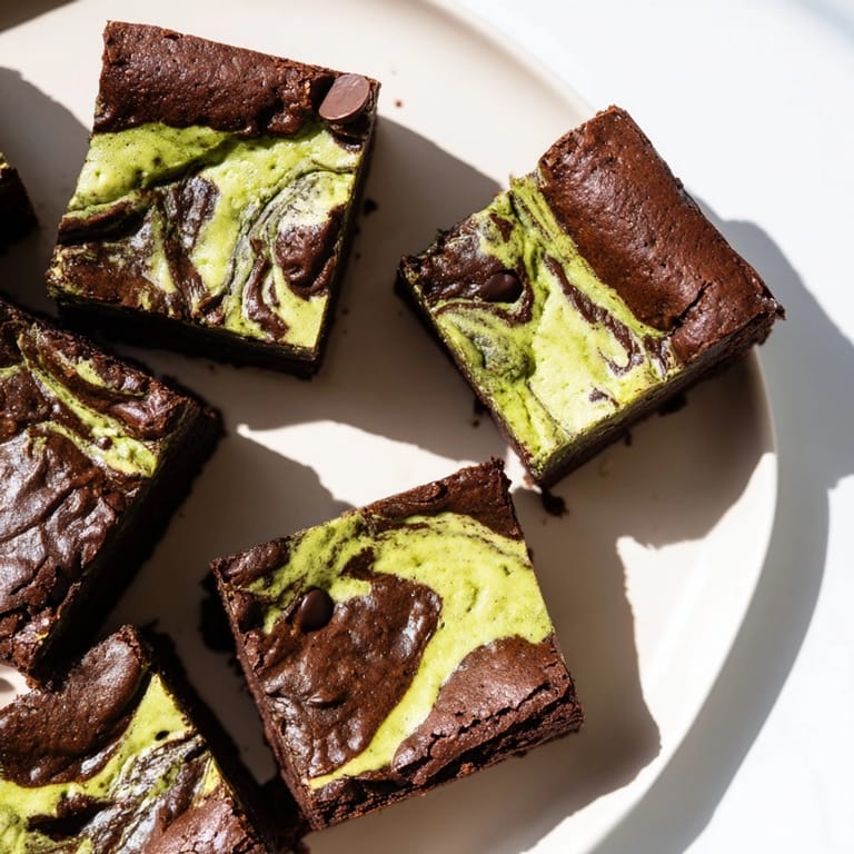 Marbled batter creates stunning Matcha Cheesecake Swirl Brownies; a gourmet dessert experience.