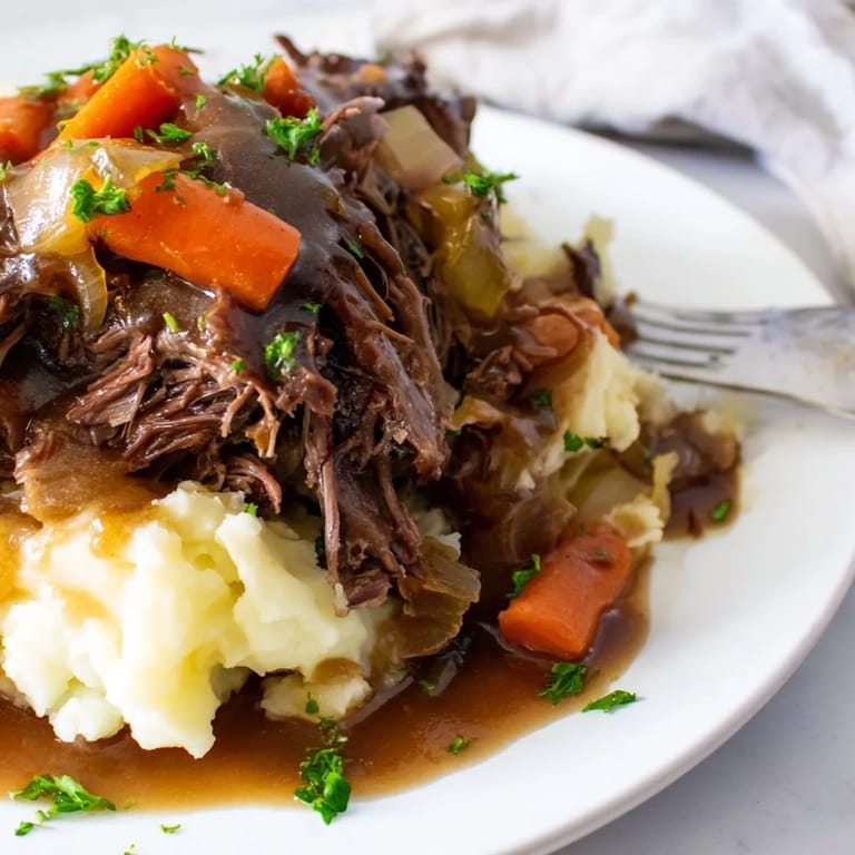 Tender beef pot roast slowly cooked to perfection with rich gravy and veggies.  