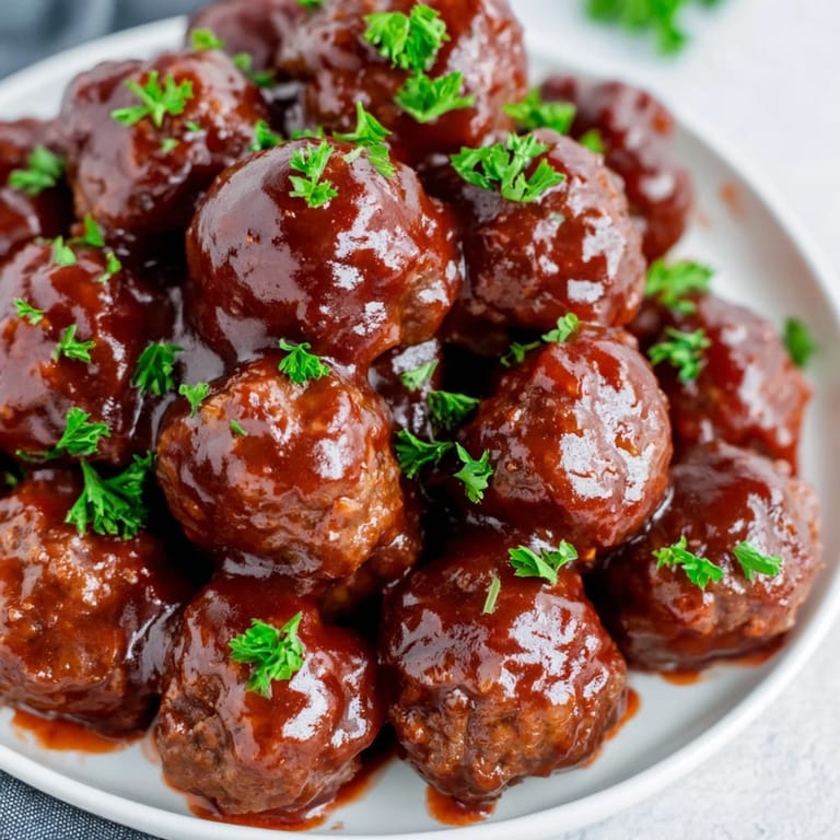 Vibrant image shows family or friends enjoying delicious cherry BBQ meatballs from the slow cooker.