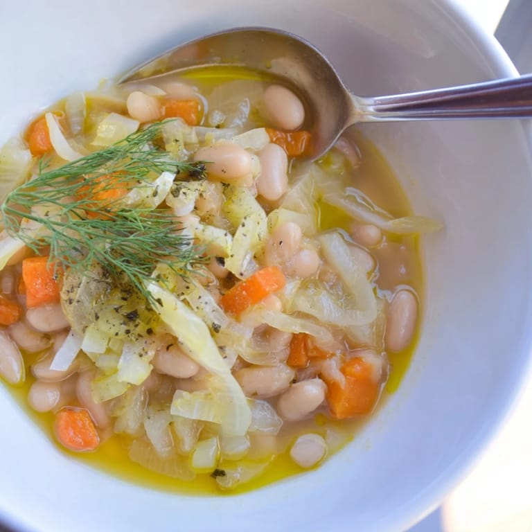 A comforting serving of Simple White Bean and Fennel Soup; a warm and flavorful vegetarian meal.