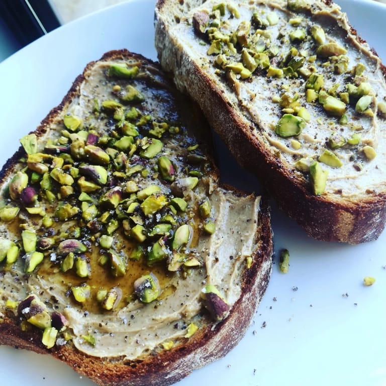 A close-up of golden pistachio butter toast, perfect for a quick and gourmet breakfast treat.