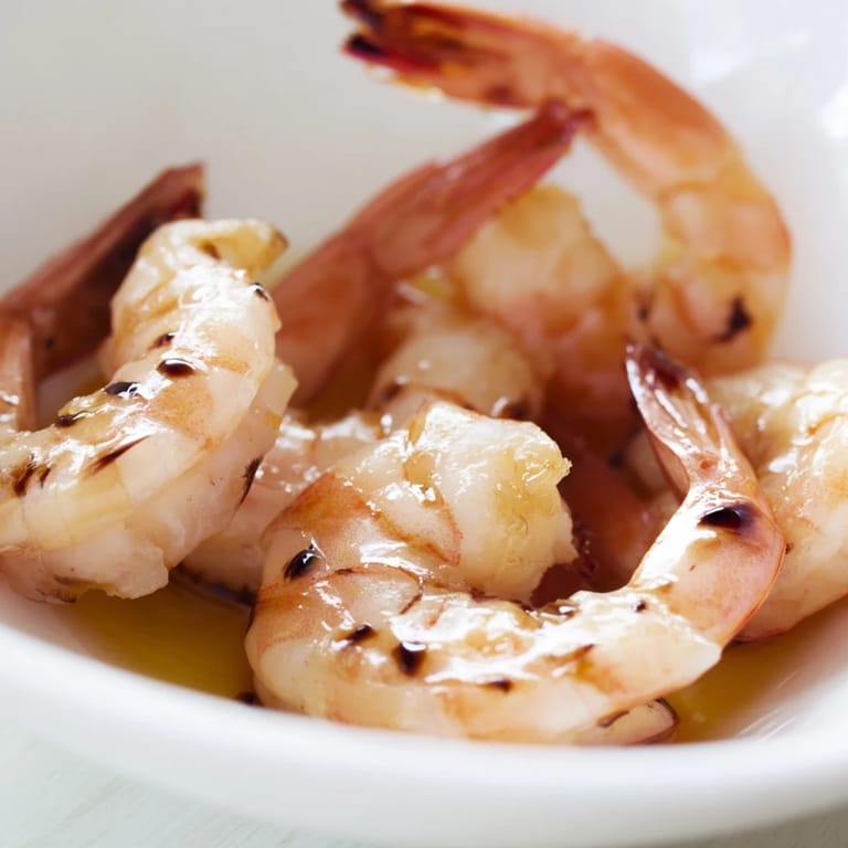 A colorful, nutrient-packed detox Buddha bowl featuring golden shrimp, green asparagus, and ripe avocado, ready for a light and satisfying meal.