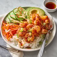 A plate of food with shrimp, rice, and vegetables.