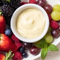 Festive Mistletoe Kiss Berry Dip Board: a beautiful display of fresh berries surrounding creamy, chilled dip.