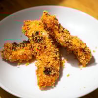 Golden, oven-baked crispy panko chicken strips, showing a satisfyingly crunchy texture ready for dipping.