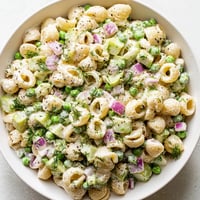 Creamy dill pickle pasta salad: A vibrant view of chilled pasta, pickles, and dressing, perfect for picnics.