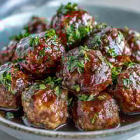 Slow-cooked Crockpot Mississippi Meatballs simmer in a savory au jus and ranch sauce with tangy pepperoncini peppers.